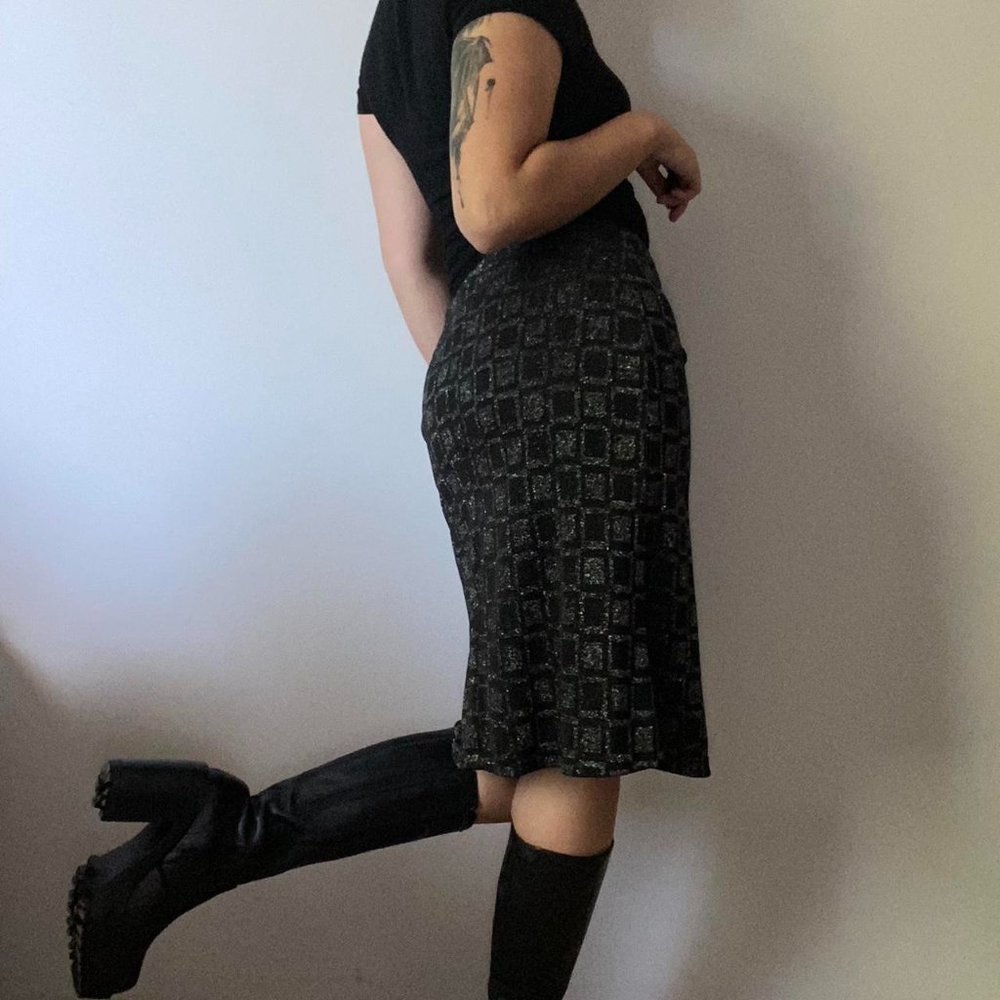 Pony Tail figure hugging black midi skirt with silver geometric print